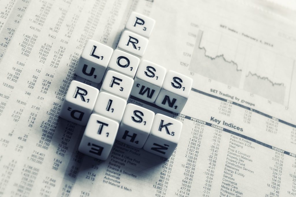 dices over newspaper, profit, loss risk